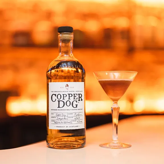 Copper Dog whisky bottle with cocktail glass