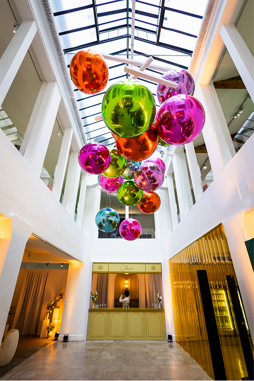 Colorful balloons hanging in a bright modern lobby